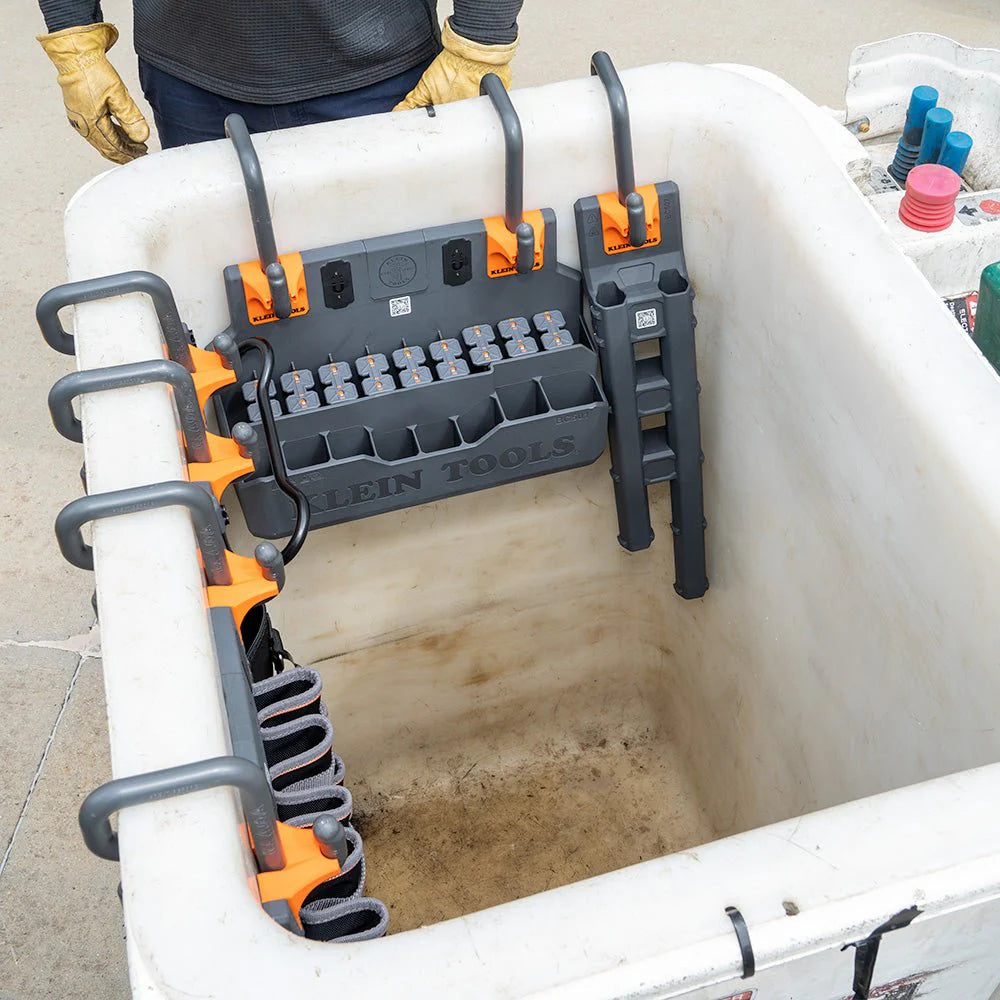 Lineman bucket setup with Klein Tools organizers, hooks, and tool holders arranged along the rim for efficient access